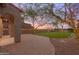Landscaped backyard with artificial turf, string lights, and a brick patio at 18196 N 92Nd St, Scottsdale, AZ 85255