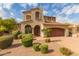 Two-story home with Spanish-style architecture,landscaped yard, and a two car garage at 18196 N 92Nd St, Scottsdale, AZ 85255