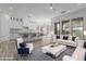 Open concept kitchen and living area with white cabinets and modern appliances at 18196 N 92Nd St, Scottsdale, AZ 85255