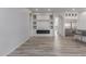 Living room with built-in shelving and fireplace, adjacent to the kitchen at 18196 N 92Nd St, Scottsdale, AZ 85255
