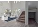Living room with high ceilings, a staircase, and a cozy sitting area at 18196 N 92Nd St, Scottsdale, AZ 85255