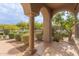 Covered porch with arched entryway, stone columns, and a view of the neighborhood at 18196 N 92Nd St, Scottsdale, AZ 85255