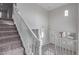 Elegant staircase with white railings and carpeted steps leading to the upper level at 18196 N 92Nd St, Scottsdale, AZ 85255