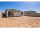 View of the backyard showing the exterior of home with patio and block wall fencing at 18366 W Poston Dr, Surprise, AZ 85387