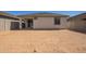 Backyard showcasing the home's exterior, covered patio and potential for landscaping at 18366 W Poston Dr, Surprise, AZ 85387