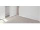 Clean bedroom with neutral carpet, white walls, and a door leading to a walk-in closet at 18366 W Poston Dr, Surprise, AZ 85387