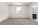 Bedroom with carpet, white trim, and window that overlooks the home's exterior at 18366 W Poston Dr, Surprise, AZ 85387