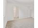 Bedroom with neutral carpet and light walls leading to an en suite bathroom at 18366 W Poston Dr, Surprise, AZ 85387