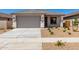 Charming single-story home featuring a two-car garage, landscaped front yard and neutral color palette at 18366 W Poston Dr, Surprise, AZ 85387