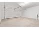 Spacious garage with a large door, concrete floor, and ample room for parking at 18366 W Poston Dr, Surprise, AZ 85387