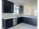 Spacious kitchen with dark cabinetry, stainless steel appliances, and a large island at 18366 W Poston Dr, Surprise, AZ 85387