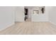 An open floorplan with stylish wood-look tile flooring, connecting the living area to the modern kitchen at 18366 W Poston Dr, Surprise, AZ 85387