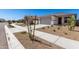 A modern house showcasing a neat two-car garage, xeriscaping and a pedestrian-friendly sidewalk at 18366 W Poston Dr, Surprise, AZ 85387