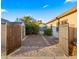 Landscaped backyard with storage shed and gates at 21752 E Estrella Rd, Queen Creek, AZ 85142