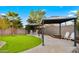 Backyard with covered patio, putting green and grass at 21752 E Estrella Rd, Queen Creek, AZ 85142