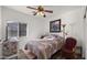 Guest bedroom with wood-look floors and ceiling fan at 21752 E Estrella Rd, Queen Creek, AZ 85142