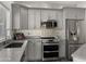 Modern kitchen with stainless steel appliances and gray cabinets at 21752 E Estrella Rd, Queen Creek, AZ 85142