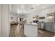 Open kitchen features island, stainless steel appliances, and wood-look flooring at 21752 E Estrella Rd, Queen Creek, AZ 85142