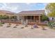 One-story home with a covered porch, xeriscaped yard, and gated entry at 22 S Mesilla Ln, Casa Grande, AZ 85194