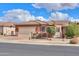 Single-story home with a two-car garage and desert landscaping at 22 S Mesilla Ln, Casa Grande, AZ 85194