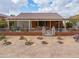 One-story home with a covered porch, xeriscaped yard, and gated entry at 22 S Mesilla Ln, Casa Grande, AZ 85194