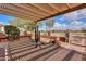 Landscaped front yard with desert plants and a pergola at 22 S Mesilla Ln, Casa Grande, AZ 85194