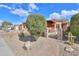 Landscaped front yard with a brick pathway and metal gate at 22 S Mesilla Ln, Casa Grande, AZ 85194