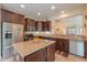 Spacious kitchen with island, stainless steel appliances, and dark wood cabinets at 22 S Mesilla Ln, Casa Grande, AZ 85194