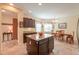 Kitchen features an island, breakfast nook, and dark wood cabinets at 22 S Mesilla Ln, Casa Grande, AZ 85194