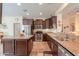 Spacious kitchen with dark wood cabinets and granite countertops at 22 S Mesilla Ln, Casa Grande, AZ 85194