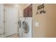 Laundry room with washer, dryer, and overhead cabinets at 22 S Mesilla Ln, Casa Grande, AZ 85194