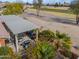 Outdoor kitchen and dining area with grill, under covered pergola at 22 S Mesilla Ln, Casa Grande, AZ 85194