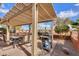 Outdoor patio with pergola, grill, and dining furniture at 22 S Mesilla Ln, Casa Grande, AZ 85194