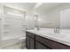 This bathroom features a double vanity, shower and a large mirror at 22831 N 183Rd Dr, Surprise, AZ 85387
