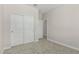 This bedroom features neutral carpet, white walls, a closet and access to another room at 22831 N 183Rd Dr, Surprise, AZ 85387
