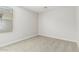 This bedroom features neutral carpet, white walls, and a window bringing in natural light at 22831 N 183Rd Dr, Surprise, AZ 85387