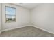 This bedroom features neutral carpet, white walls, and a window bringing in natural light at 22831 N 183Rd Dr, Surprise, AZ 85387
