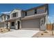 Beautiful two-story home featuring a two-car garage, covered entry, and desert-style front yard landscaping at 22831 N 183Rd Dr, Surprise, AZ 85387