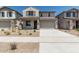 Attractive two-story home with a two-car garage, covered porch, and desert-friendly front yard landscaping at 22831 N 183Rd Dr, Surprise, AZ 85387