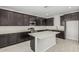 Stylish kitchen featuring rich wood cabinetry, stainless steel appliances, quartz countertops, and a central island at 22831 N 183Rd Dr, Surprise, AZ 85387