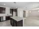 Well-appointed kitchen with dark wood cabinets, stainless appliances, a spacious island, and tile flooring at 22831 N 183Rd Dr, Surprise, AZ 85387