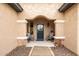 Covered entryway with blue door, stone accents, and comfortable seating at 26689 W Burnett Rd, Buckeye, AZ 85396