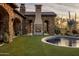 Stunning outdoor space with pool, fireplace, and lush landscaping at 27256 N 97Th Pl, Scottsdale, AZ 85262