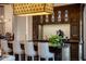 Elegant bar with dark wood cabinetry and a granite countertop at 27256 N 97Th Pl, Scottsdale, AZ 85262