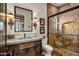 Bathroom with a walk-in shower and dark wood vanity at 27256 N 97Th Pl, Scottsdale, AZ 85262