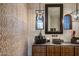 Powder room with unique stone sink and decorative wall at 27256 N 97Th Pl, Scottsdale, AZ 85262