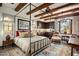Spacious bedroom with a metal bed frame and rustic decor at 27256 N 97Th Pl, Scottsdale, AZ 85262