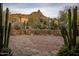 Landscaped courtyard with a stone patio and desert plants at 27256 N 97Th Pl, Scottsdale, AZ 85262