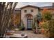 Stunning stone exterior with arched entryway and desert landscaping at 27256 N 97Th Pl, Scottsdale, AZ 85262