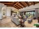 Bright living room with high ceilings, wood beams, and access to patio at 27256 N 97Th Pl, Scottsdale, AZ 85262